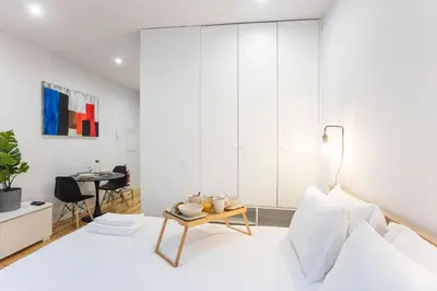 a living room with a bed and a table at Trendy Vintage Downtown by LovelyStay in Porto