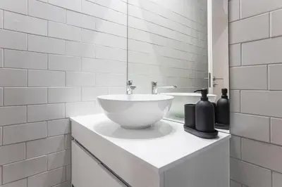 a white bathroom with a sink and a mirror at Trendy Vintage Downtown by LovelyStay in Porto