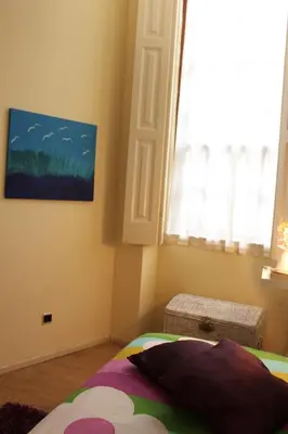 a bedroom with a bed and a window at Oportobestview-Garden in Porto