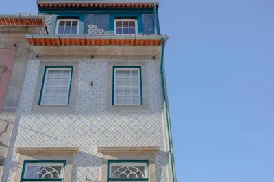 a building with windows on the side of it at Liiiving in Porto - Cedofeita Charming Apartment in Porto