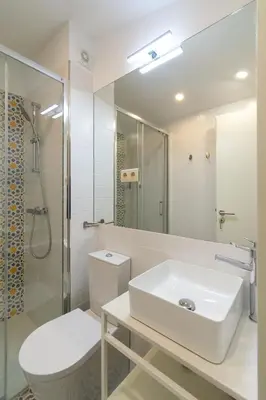 two beds in a bedroom with wooden ceilings at Portucale Guest House- Self check-in in Porto