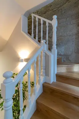 a bedroom with a large bed and a night stand at Portucale Guest House- Self check-in in Porto