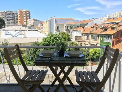 a table and chairs on a balcony with a view at PinPorto City Center III in Porto
