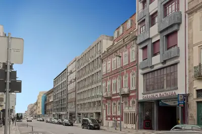 a row of buildings on a city street with cars at Luxury Prime Batalha Apartments in Porto