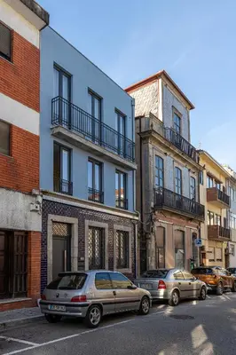 two cars parked in front of buildings on a street at Alvaro's Charming Loft by MP in Vila Nova de Gaia