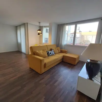 a living room with a couch and a window at OportoCityView - Ceuta Aliados in Porto