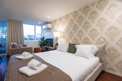 a bedroom with a large bed with towels on it at Bombarda Apartments by LovelyStay in Porto