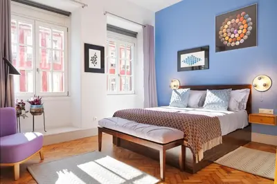 a bedroom with a bed and a blue wall at Blue Moon Studio in Porto