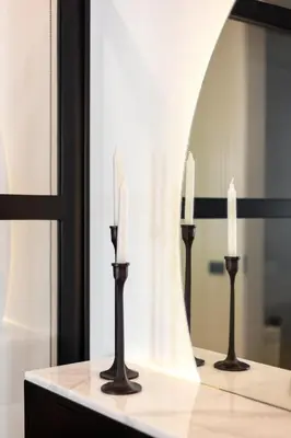 two candles on a table in front of a mirror at Conceição Premium Downtown Apartment by DA'HOME in Porto