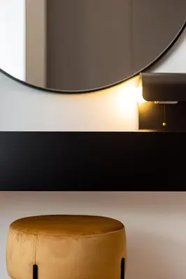 a wooden stool sitting in front of a mirror at Conceição Premium Downtown Apartment by DA'HOME in Porto