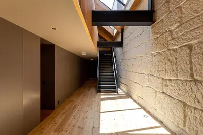 a staircase in a room with a brick wall at Conceição Premium Downtown Apartment by DA'HOME in Porto