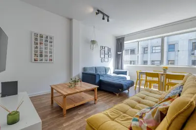 a living room with a couch and a table at Travel & Live Bolhão apartments in Porto