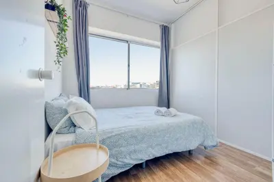 a small bedroom with a bed and a window at Travel & Live Bolhão apartments in Porto