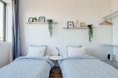 two beds sitting next to each other in a room at Travel & Live Bolhão apartments in Porto