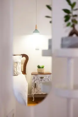 a bedroom with a bed and a table with a plant on it at Riverside 2 Bedroom Apartment by DA'HOME in Porto