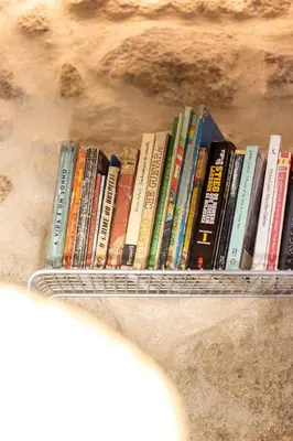 a rack of books sitting on a shelf at Riverside 2 Bedroom Apartment by DA'HOME in Porto