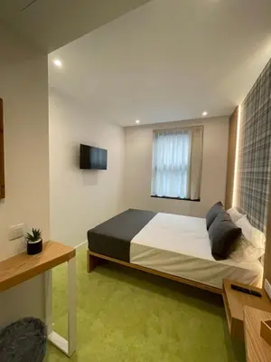 a woman sitting at a desk in a room at MyStay Porto São Bento in Porto