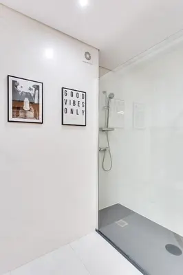 a white room with a sign on the wall at Bonjardim Downtown Apartments by DA'HOME in Porto