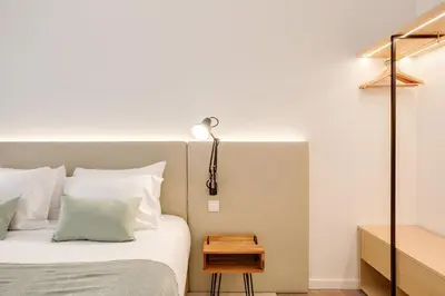 a bedroom with a bed with a lamp on it at Virtudes Premium Apartment by DA'HOME in Porto