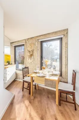 a kitchen and dining room with a table and chairs at Riva House in Porto