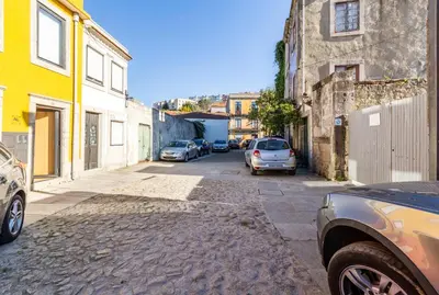 a street with cars parked on the side of a building at Riva House in Porto