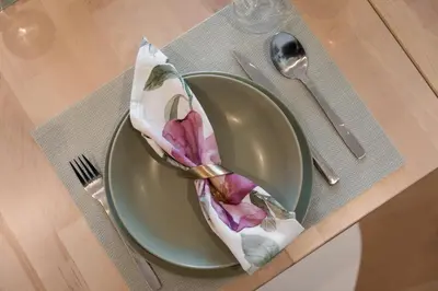 a green plate with a napkin on a table at Alvaro´s Loft Downtown in Porto