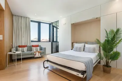 a bedroom with a bed and a couch at Alvaro´s Loft Downtown in Porto