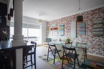 a brick wall in a room with a table and chairs at HEART OF THE CITY 3 ! in Vila Nova de Gaia