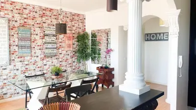 a dining room with a brick wall at HEART OF THE CITY 3 ! in Vila Nova de Gaia