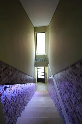a stairway with a window in a room with purple tiles at HEART OF THE CITY ! in Porto