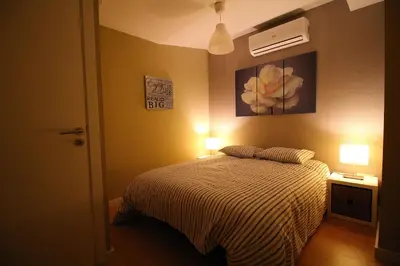a bedroom with a bed with two lights on at HEART OF THE CITY ! in Porto