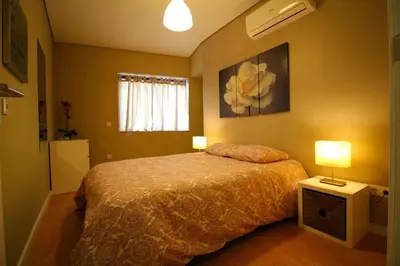 a bedroom with a bed and two lamps in it at HEART OF THE CITY ! in Porto