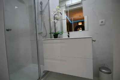 a white bathroom with a sink and a shower at HEART OF THE CITY ! in Porto