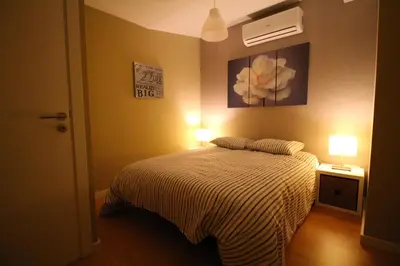 a bedroom with a bed with two lights on it at HEART OF THE CITY ! in Porto