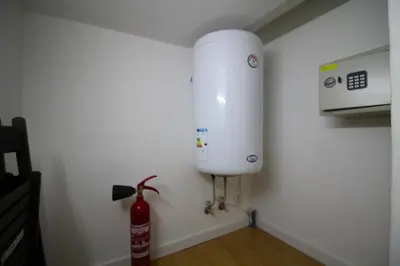 a water tank in a corner of a room at HEART OF THE CITY ! in Porto