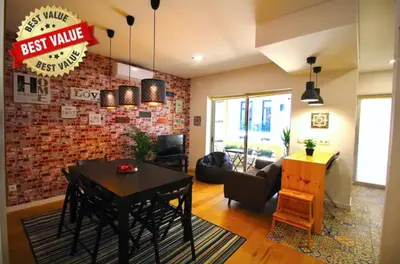 a living room with a black table and a brick wall at HEART OF THE CITY 5 ! in Porto