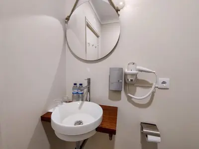 a bathroom with a white sink and a mirror at Salty Swell in Porto
