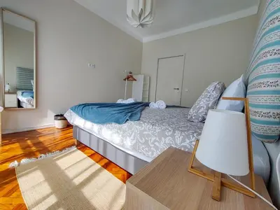 a bedroom with a large bed in a room at Salty Swell in Porto