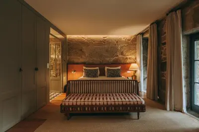 a bedroom with a bed and a couch in a room at Torel Saboaria in Porto