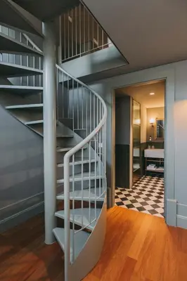 a spiral staircase in a house with a hallway at Torel Saboaria in Porto
