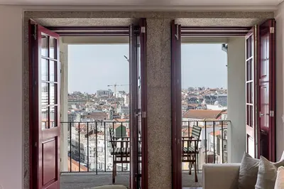 an open door to a balcony with a view of a city at Downtown Studio w/ Gorgeous Views by LovelyStay in Porto