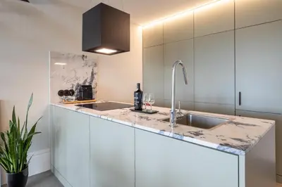 a kitchen with a sink and a staircase at Panoramic Historic Views Private Balconies - Apt E in Porto