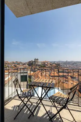a bedroom with a bed in a room with a window at Panoramic Historic Views Private Balconies - Apt E in Porto