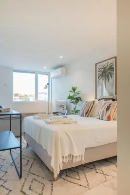 a bedroom with a large bed and a table at Liiiving in Porto - Luxury Gallery Apartment II in Porto