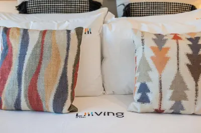 two pillows are sitting on a bed next to at Liiiving in Porto - Luxury Gallery Apartment II in Porto