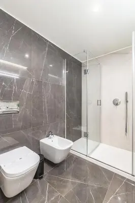 a bathroom with a toilet and a sink and a shower at OPorto Design Flat in Porto