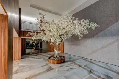 a vase of flowers on a table in a room at OPorto Design Flat in Porto