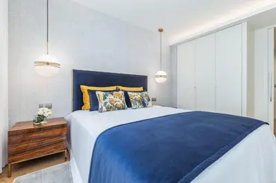 a bedroom with a blue bed and two lamps at OPorto Design Flat in Porto