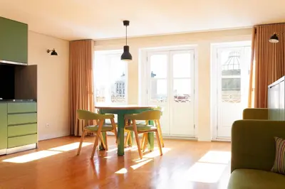 a kitchen with a table and chairs in a room at VIVA Three Magi Residence in Porto