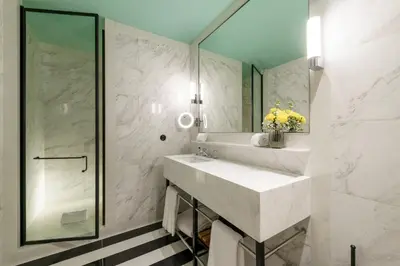 a bathroom with a sink and a shower at The Editory Boulevard Aliados Hotel - Preferred Hotels in Porto